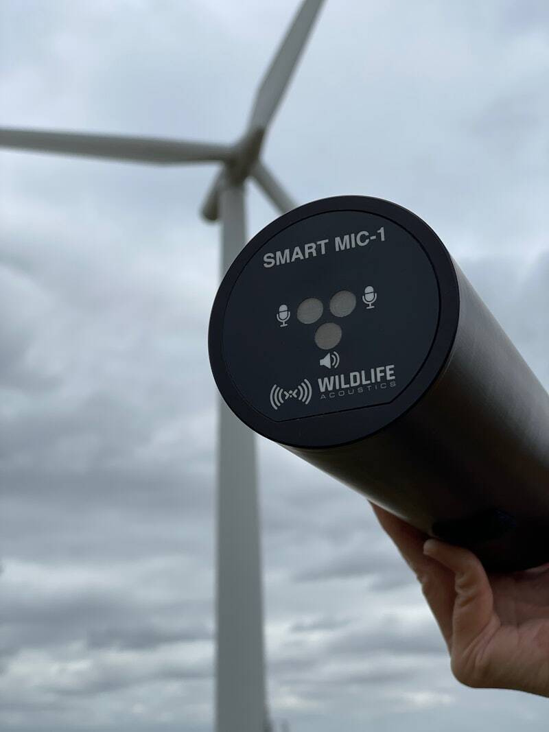 SMART Microphone with wind turbine in background.